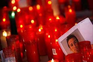 A picture of  Antonio Puerta is placed among candles