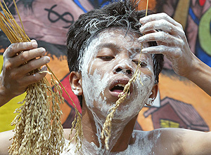 An activist playing the role of a poor farmer protests during an anti-global warming campaign in Jakarta 