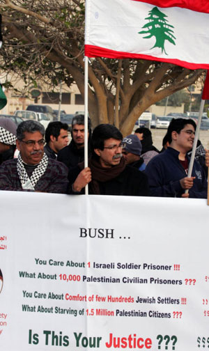 Demonstrators, carrying a Lebanese flag, protest outside the US Embassy in Manama 12 January 2008 against US President George W. Bush's visit to Bahrain