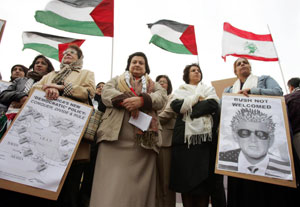 Women, carrying anti-Bush placards protest outside the US Embassy in Manama 