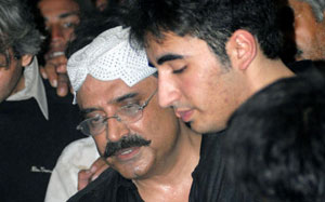 Asif Ali Zardari (L) husband of former Pakistani premier Benazir Bhutto comforts his son Bilawal (R) 