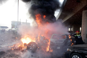 A Lebanese fireman extinguishs a fire after an explosion in the Beirut suburbs January 25, 2008. The bomb in Beirut on Friday targeted a car used by a senior police official and killed at least three people, security sources said. REUTERS