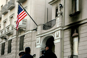 Serb police stand in front of the damaged facade of the US embassy in Belgrade 