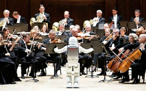 Honda's ASIMO robot conducts the Detroit Symphony Orchestra as it performs 'Impossible Dream' during a concert in Detroit, Tuesday, May 13, 2008.
