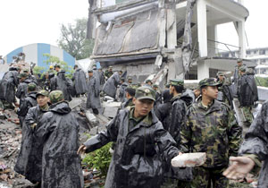 سربازان ارتش خلق چین در حال آواربرداری از یک دبیرستان در دوجینگ‌یامگ، یکی از شهرهای نزدیک به مرکز زلزله