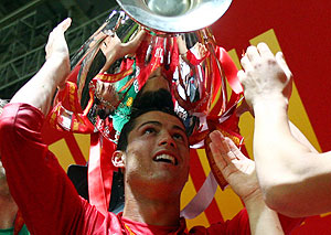 Manchester United's Cristiano Ronaldo celebrates with the trophy after beating Chelsea in the final of the UEFA Champions League football match at the Luzhniki stadium in Moscow on May 21, 2008. 