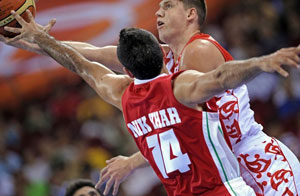 Russia's Viktor Khryapa (R) is challenged by Iran's Mohammadsamad Nikkah during their men's preliminary round group A match at the Olympic Basketball Arena during the 2008 Beijing Olympic Games on August 10, 2008.