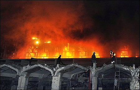 Firefighters tackle the blaze caused by the blast, which consumed a large portion of the hotel