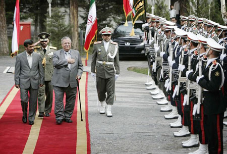 Mahmoud Ahmadinejad (L) walks with his Iraqi counterpart Jalal Talabani (3rd L) during an official welcoming ceremony in Tehran, February 27, 2009.