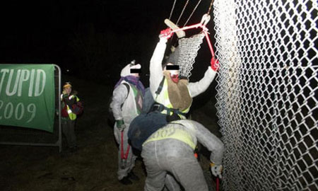 Plane Stupid climate protesters break through the perimeter fence at Aberdeen airport. Photograph: Plane Stupid/PA 