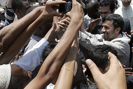 Iranian President Mahmoud Ahmadinejad (R) shakes hands during a meeting with thousands of Muslim Shia community members in the Kenyan coastal town of Mombasa, February 25, 2009. 