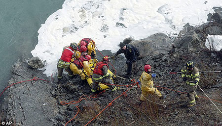 Rescuers finally pull the man from the ice-fringed Niagara River - a full half hour after he leapt in