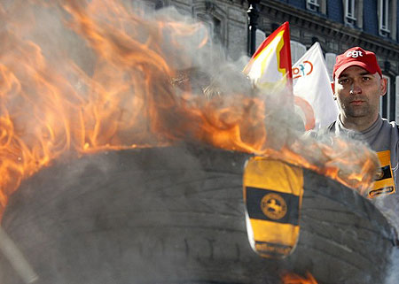 Employees from the Continental tyre company in Clairoix burn tyres during a protest march in Compiegne March 19, 2009