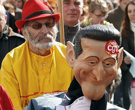  demonstrator holds a mask resembling French President Nicolas Sarkozy during a protest march in Lyon March 19, 2009