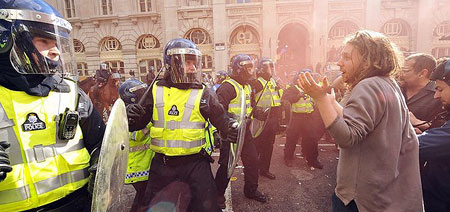 Policemen (L) clash with protestors outside the Bank of England in London