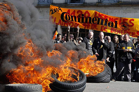 Employees from the Continental tyre company in Clairoix burn tyres during a protest march in Compiegne March 19, 2009 as public and private sectors take part in demonstrations all over France to denounce the government's economic policies. 