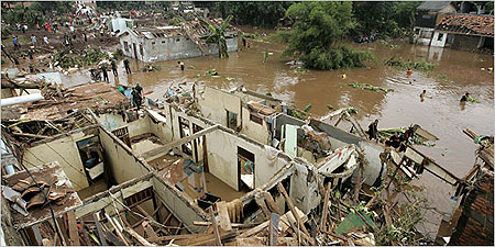 Water and mud cascaded through hundreds of houses Friday on the outskirts of Jakarta, Indonesia, after a dam burst