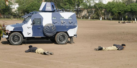 Policemen lie injured at the site of a shooting near a police training centre in Lahore March 30, 2009