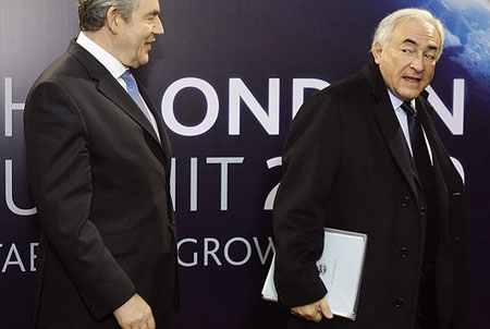 Britain's Prime Minister Gordon Brown (L) talks with International Monetary Fund (IMF) Managing Director Dominique Strauss-Kahn upon his arrival for the G20 summit at the ExCel centre, in east London, on April 2, 2009.