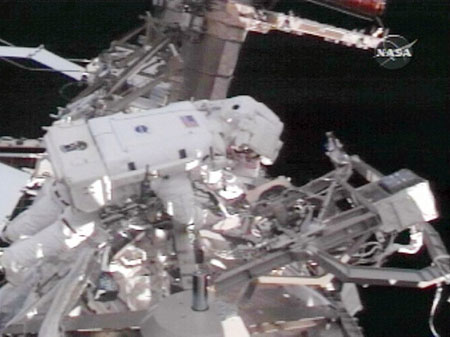 This NASA video grab shows Space shuttle Discovery Mission Specialist's Joseph Acaba (L) and Richard Arnold (R) outside of the Internationl Space Station on March 23, 2009 as they attempt to free up a rack during the third of three planned spacewalks to service items on the station.