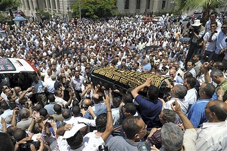Some thousands of Egyptians surround the coffin of 32-year old pregnant Egyptian woman Marwa el-Sherbini, Monday July 6, 2009, who was stabbed by a German man in a courtroom in eastern Germany last week, during her funeral in Alexandria, Egypt.