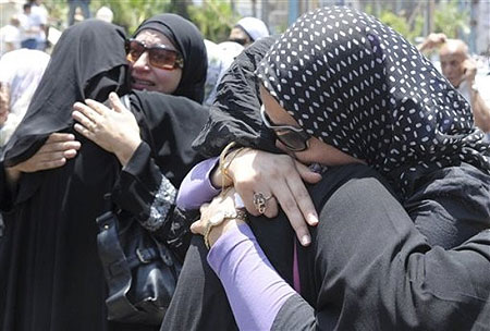 Egyptians react during the funeral for 32-year old pregnant Egyptian woman Marwa el-Sherbini, Monday July 6, 2009, who was stabbed by a German man in a courtroom in eastern Germany last week, during her funeral in Alexandria, Egypt