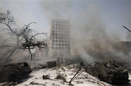 The Iraqi Foreign Ministry is seen through a haze of smoke after a massive bomb attack in Baghdad, Iraq, Wednesday, Aug. 19, 2009