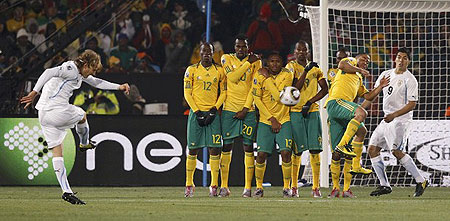Uruguay's Diego Forlan (L) takes a free kick during a 2010 World Cup Group A soccer match against South Africa at Loftus Versfeld stadium in Pretoria June 16, 2010.