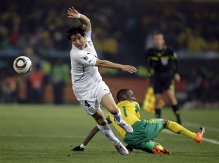 Uruguay's Jorge Fucile, left, goes for the ball during the World Cup group A soccer match between South Africa and Uruguay at the Loftus Versfeld Stadium in Pretoria, South Africa, Wednesday, June 16, 2010