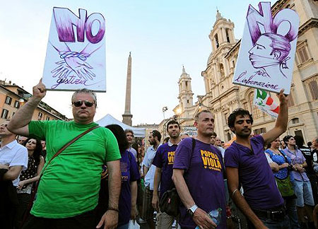 Demonstrators holds banners during a rally against the so called "gag law" in Rome on July 1. Virtually no news was published in Italy as journalists went on strike against a bill curbing the use of wiretaps and their publication proposed by the government of Silvio Berlusconi. 