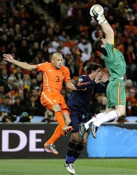 Spain goalkeeper Iker Casillas, right, makes a save as Netherlands' John Heitinga, left, tries to score a goal during the World Cup final soccer match between the Netherlands and Spain at Soccer City in Johannesburg, South Africa, Sunday, July 11, 2010.