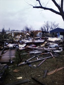 In this photo taken with a cell phone, damage to a barn and a house is shown in Cincinnati